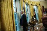 FILE PHOTO: U.S. President Trump looks out window of the Oval Office following an interview with Reuters at the White House in Washington